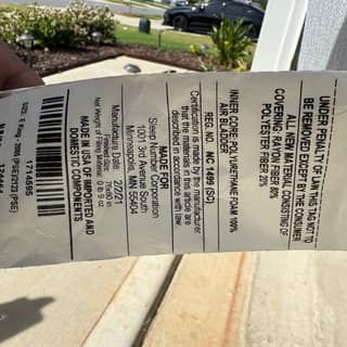 Mattress law tag on a piece of furniture being hauled away
