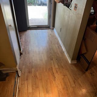 Clear hallway leading to the back door after junk removal